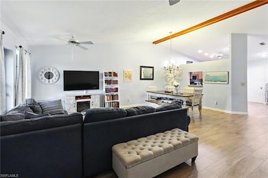 Living room with baseboards, light wood-style floo