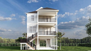 Coastal inspired home with a balcony and a front y
