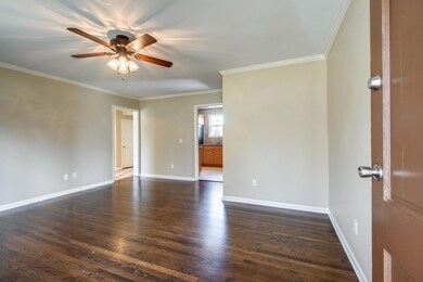 The living room has gorgeous and newly refinished oak hardwood floors.