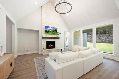 Featuring a beautiful stone fireplace as the focal
