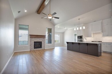 Kitchen featuring ceiling fan with notable chandel