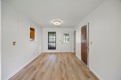 Entryway with light wood finished floors and baseboards