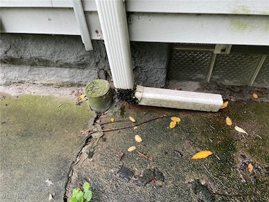 Downspout on driveway side of the house