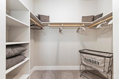 Spacious closet featuring carpet flooring