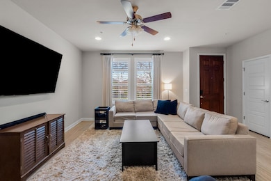 Living room featuring recessed lighting, baseboar