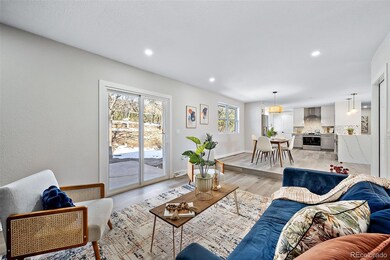 Family room with wood burning fireplace and walk out slider to patio.