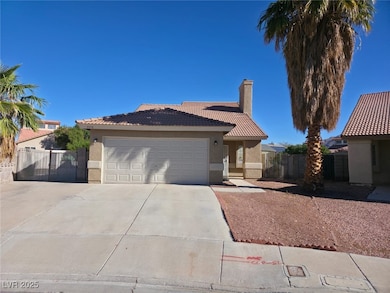 Ranch-style home featuring a tile roof, stucco siding, concrete driveway, a chimney, and a gate