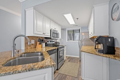 Kitchen with decorative backsplash, appliances wit