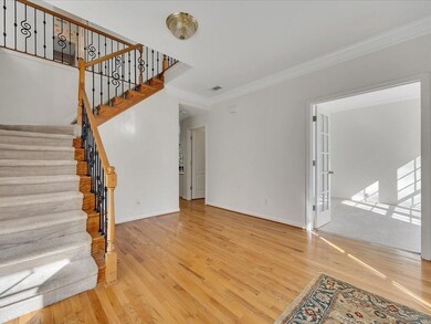 Unfurnished living room with baseboards, stairway,