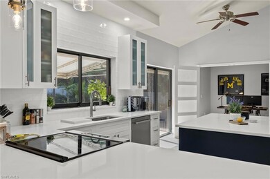 Kitchen with lofted ceiling, ceiling fan, decorati