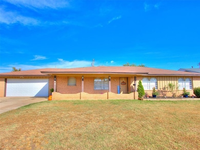 Single story home with a front lawn, a porch, and brick siding