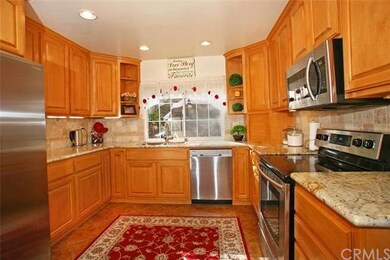 Upgraded kitchen with maple cabinets and tile floo