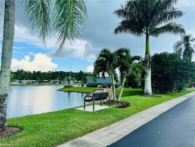 View of property's community with a lawn and a wat