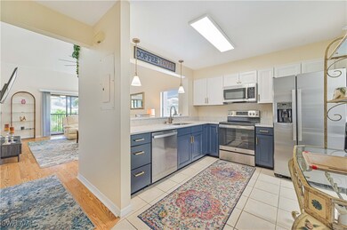 Kitchen featuring white cabinetry, blue cabinets,