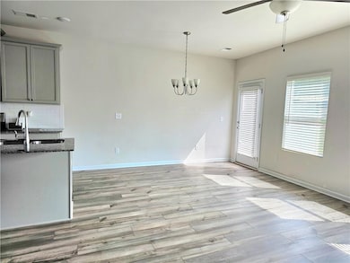 Unfurnished dining area with visible vents, basebo