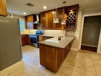 Kitchen featuring kitchen peninsula, appliances wi