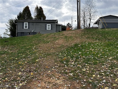 Back of house featuring a yard