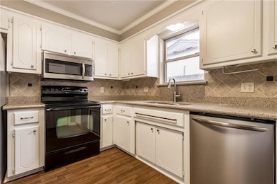 Kitchen with appliances with stainless steel finis