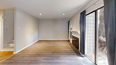Unfurnished living room featuring a tiled fireplac