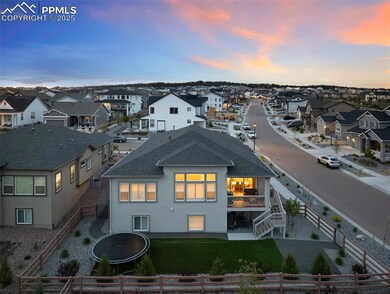 Back of house at dusk featuring a residential view, a shingled roof, stucco siding, and stairway