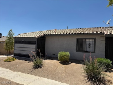 View of front of house featuring a tiled roof and stucco siding
