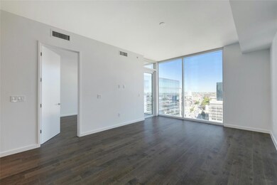 Empty room with a wall of windows, dark wood-styl