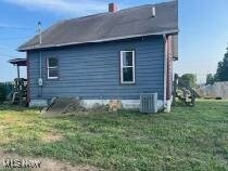Side of home with entrance into basement