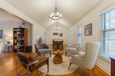 Living room with crown molding, wood-type flooring