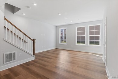 Unfurnished living room with hardwood / wood-style