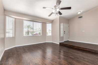 Empty room featuring dark wood-style flooring, lof