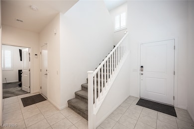 Entryway featuring light tile patterned floors, st