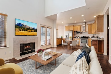 Living area featuring recessed lighting, a fireplace, and dark wood-type flooring
