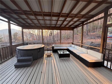 screened in back porch/hot tub and view