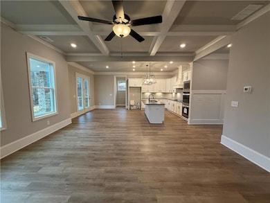 Kitchen with coffered ceiling, sink, pendant light