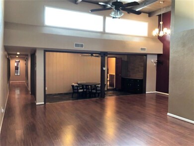 Unfurnished living room featuring a towering ceili
