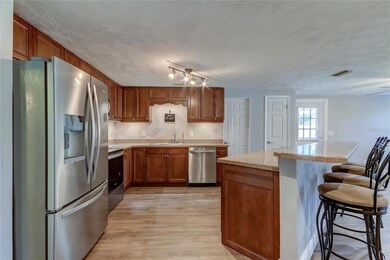 Kitchen With Island/Windowed Door Leads To Backyard