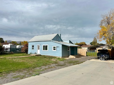 Bungalow featuring a carport and concrete driveway