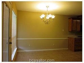 Unfurnished dining area with a chandelier and base