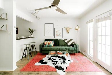 Living area featuring ceiling fan and wood finish