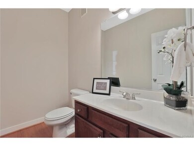 Half Bathroom - 5 x 7, hardwood floor, light fixture, ventilation fan, cultured marble vanity with wall mirror above
