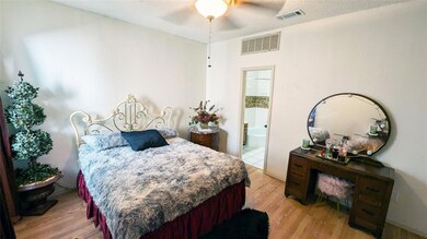Bedroom with connected bathroom, a textured ceilin