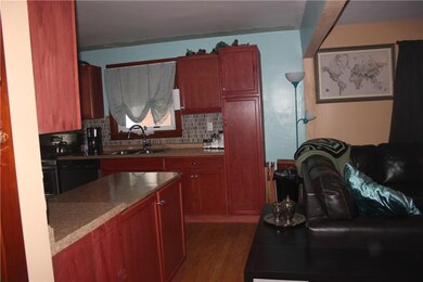KITCHEN WITH ISLAND AS A DIVIDER TO LIVING ROOM