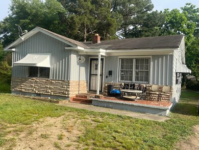Back of house with a lawn