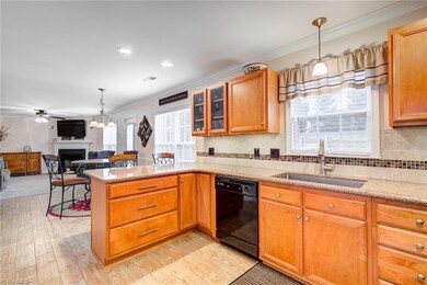 The New wood plank tile is stunning and matches the New kitchen too!  This huge kitchen is also open to the casual dining & family rooms.
