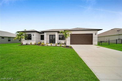 Prairie-style home featuring a garage and a front yard