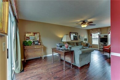 Sliding glass doors lead from the living room to outdoor entertainment....