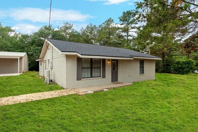 Side view of home and metal building. Home is supplied by a private water well.