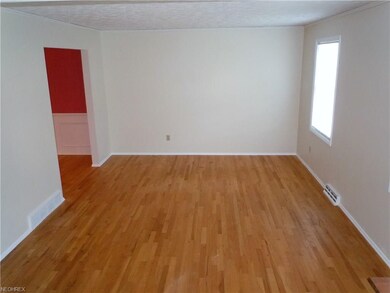 Large and bright living room with gleaming hardwoo