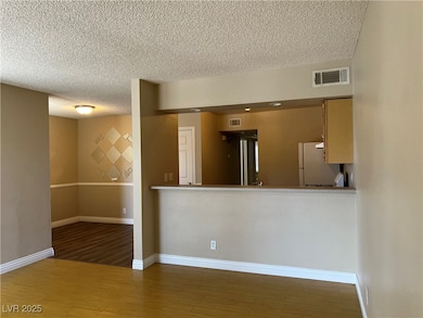Kitchen with freestanding refrigerator, a textured