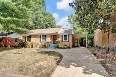 Ranch-style house with a carport and a front yard